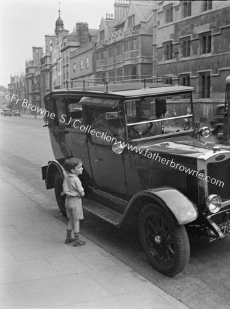 'CURIOSITY' SMALL BOY AT CAR